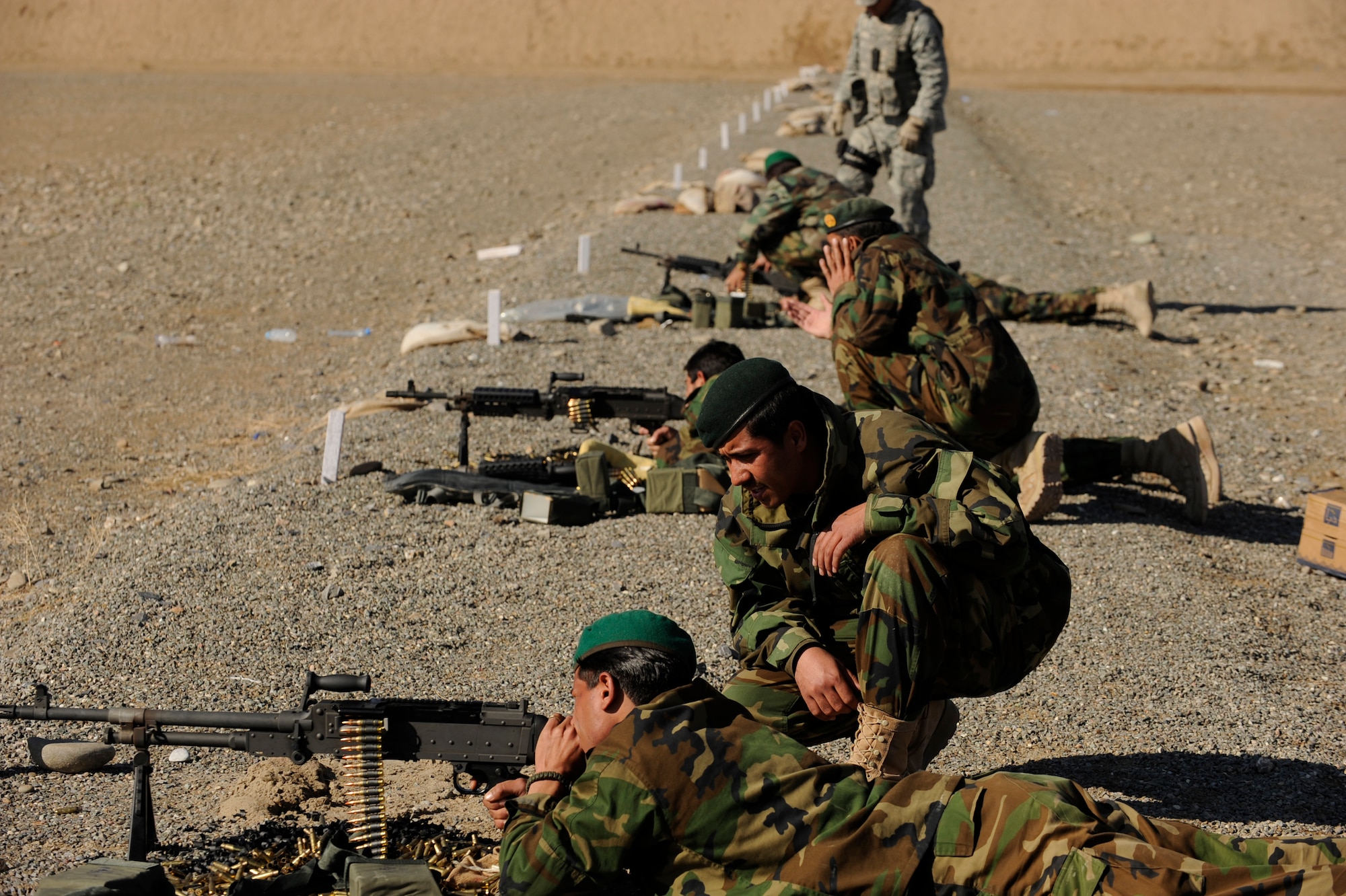 Afghanistan National Army Air Corps soldiers engage targets with 
M-240B machine guns during weapons familiarization training in Kandahar, Afghanistan, Jan. 4, 2010.  The Afghan soldiers are training with 738th Air Expeditionary Advisory Group Airmen to gain the skills needed to fulfill security requirements independently.  (U.S. Air Force photo/Staff Sgt. Manuel J. Martinez/Released) 
