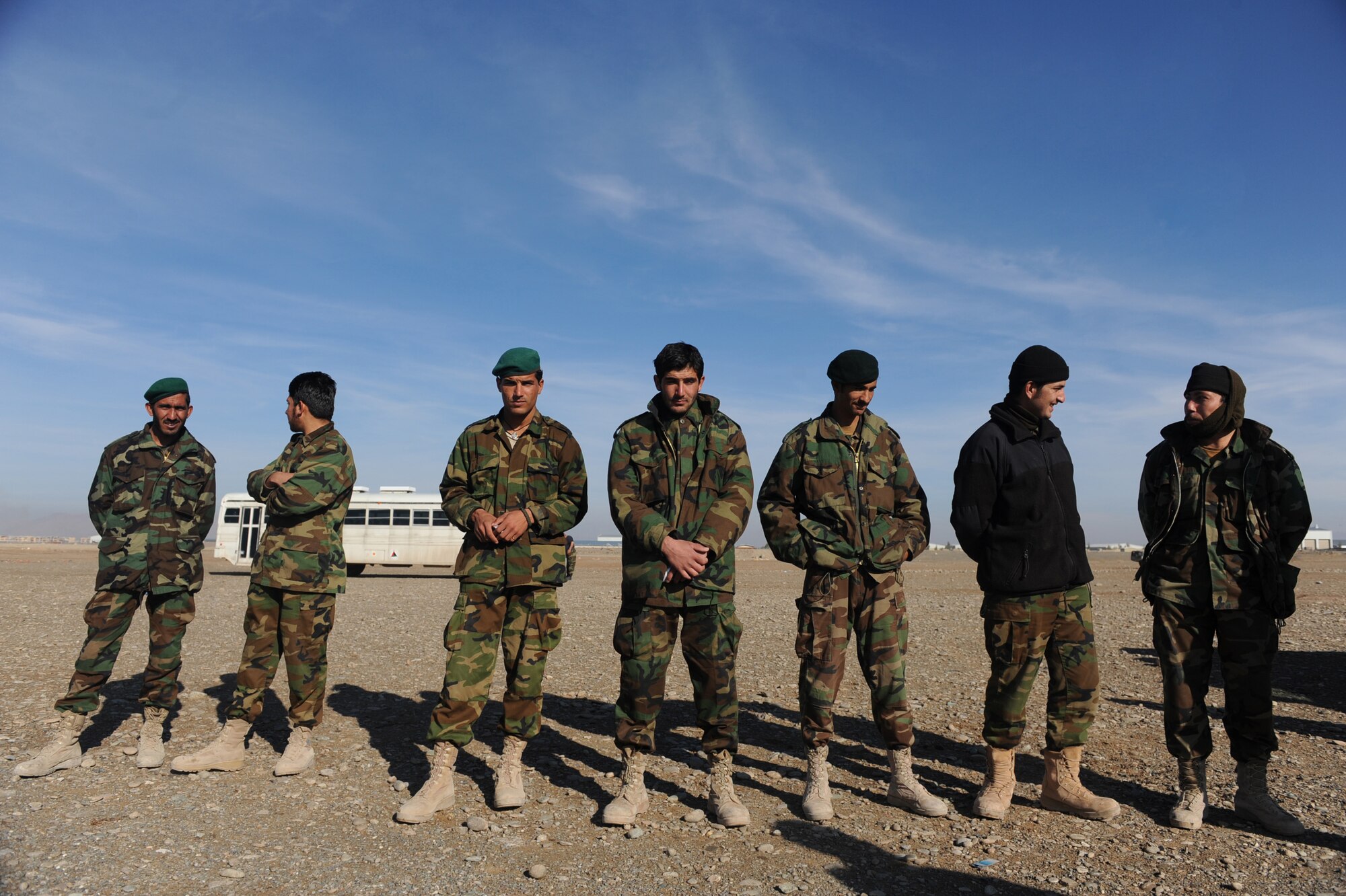 Afghanistan National Army Air Corps soldiers take a break for a photo op during M-240B machine gun familiarization training in Kandahar, Afghanistan, Jan. 4, 2010. The Afghan soldiers are training with 738th Air Expeditionary Advisory Group Airmen to gain the skills needed to fulfill security requirements independently.  (U.S. Air Force photo/Staff Sgt. Manuel J. Martinez/Released)