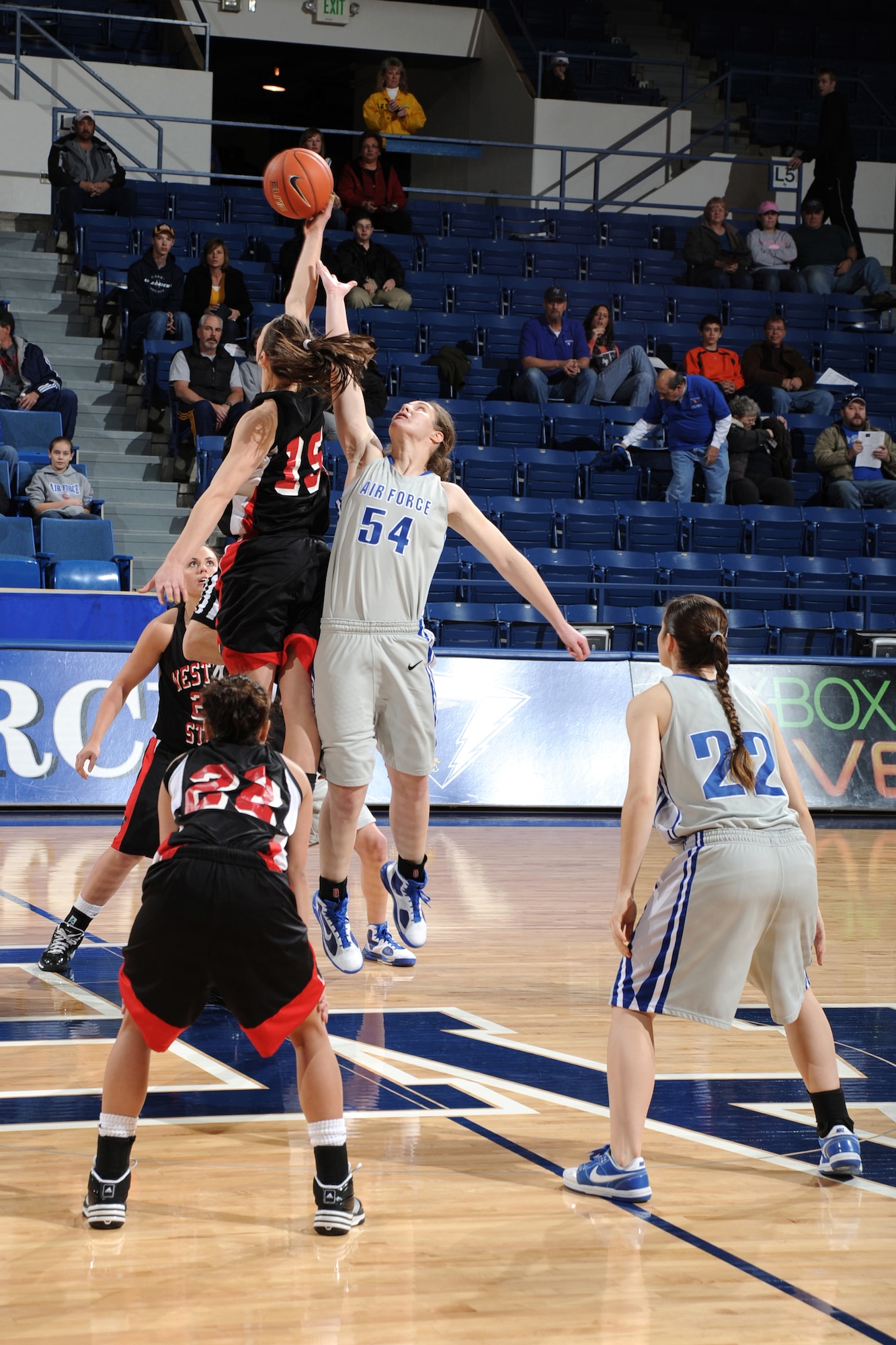 Western State freshman forward Katie Hall beats Air Force junior center Liz Dunsworth on the tipoff during the Falcons-Mountaineers game at the Air Force Academy's Clune Arena Jan. 2, 2010. Dunsworth, a native of Rock Island, Ill., had four rebounds in Air Force's 74-66 victory. (U.S. Air Force photo/Johnny Wilson)