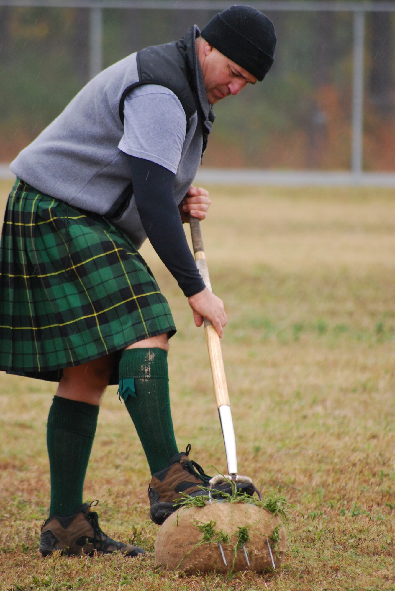 MOODY AIR FORCE BASE, Ga. -- A participant of the Scottish Highland Games uses a pitchfork to hurl a 16-pound burlap bag stuffed with straw over a horizontal bar here Dec. 12. The games were held at Moody’s Magnolia Grove Housing area. (U.S. Air Force photo by Senior Airman Calinn Weber)