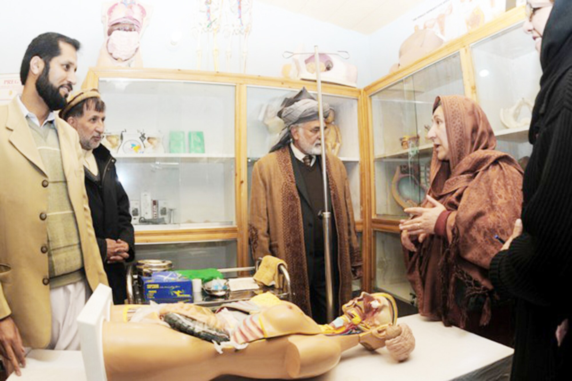 Fazlullah Wahidi (center) and Pashtoon Azfar (right) Afghan midwife committee chief take a tour of the Kunar midwifery program training center Dec. 22 in Asadabad, Afghanistan. The midwifery program will train 24 women from Kunar province in an 18-month long course on providing prenatal and postpartum care to expectant mothers and their babies to decrease infant mortality rates. Mr. Wahidi is the Kunar provincial governor. Mrs. Azfar is the Afghan midwife committee chief. (U.S. Air Force photo/ Tech. Sgt. Brian Boisvert) 
