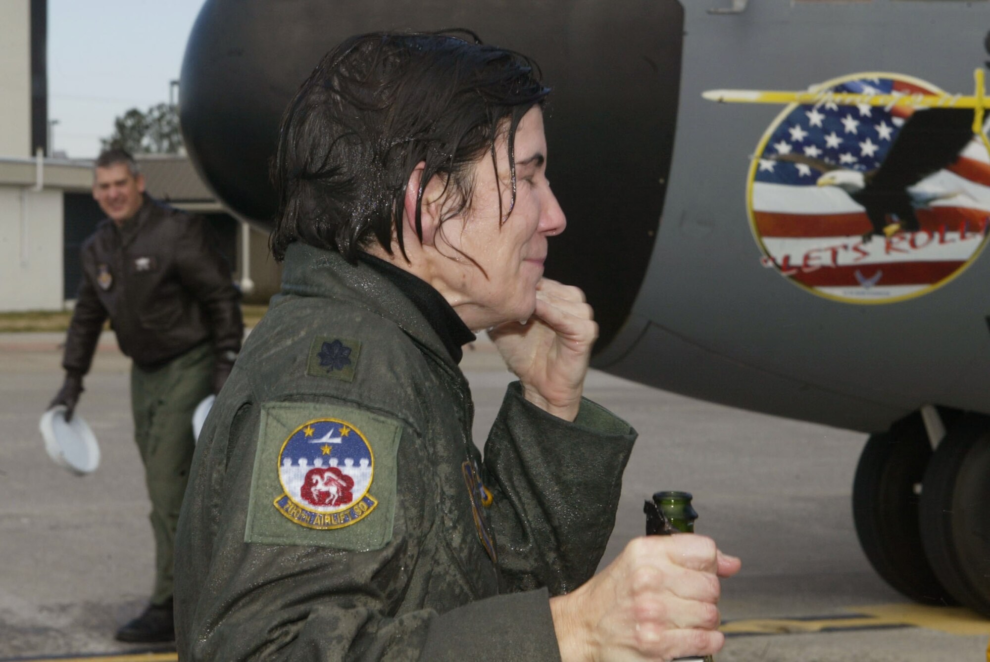 Despite frigid temparatures, Lt. Col. Arlene Salmon from the 700th Airlift Squadron receives an ice water soaking from her family and crew members after she completed her final flight Jan. 4. (U.S. Air Force photo/Don Peek) 