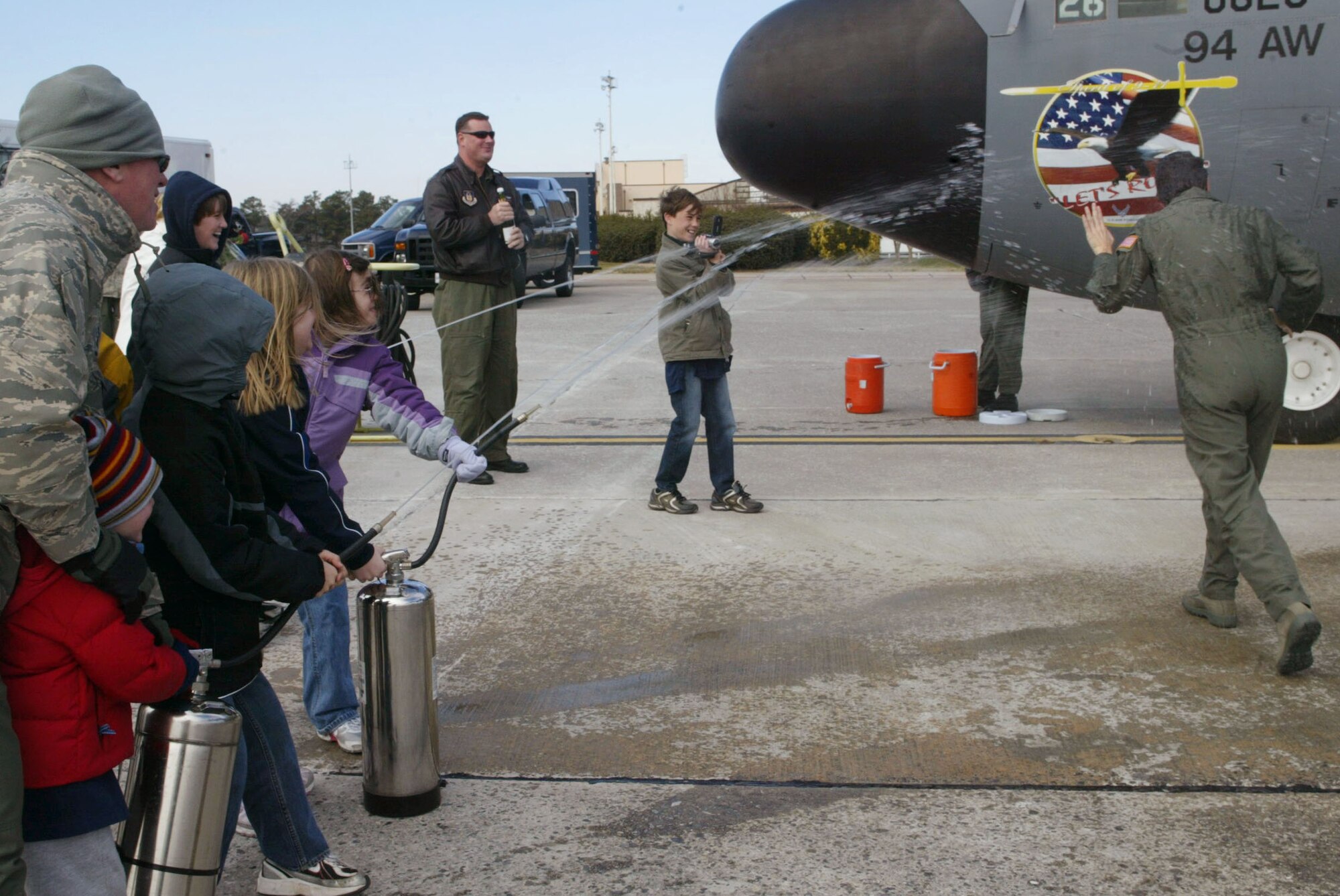 Despite frigid temparatures, Lt. Col. Arlene Salmon from the 700th Airlift Squadron receives an ice water soaking from her family after she completed her final flight Jan. 4. (U.S. Air Force photo/Don Peek) 