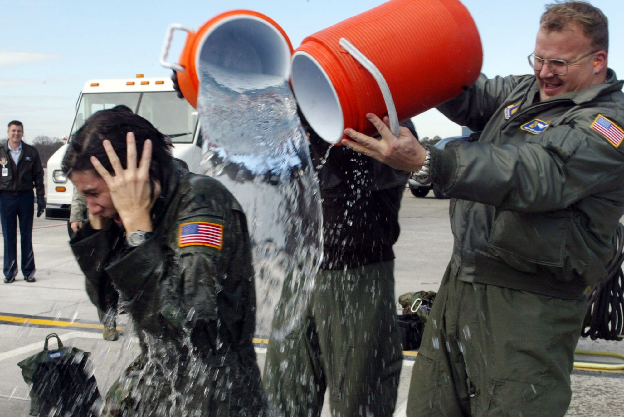 Despite frigid temparatures, Lt. Col. Arlene Salmon from the 700th Airlift Squadron receives an ice water soaking provided by crew members after she completed her final flight Jan. 4. (U.S. Air Force photo/Don Peek) 