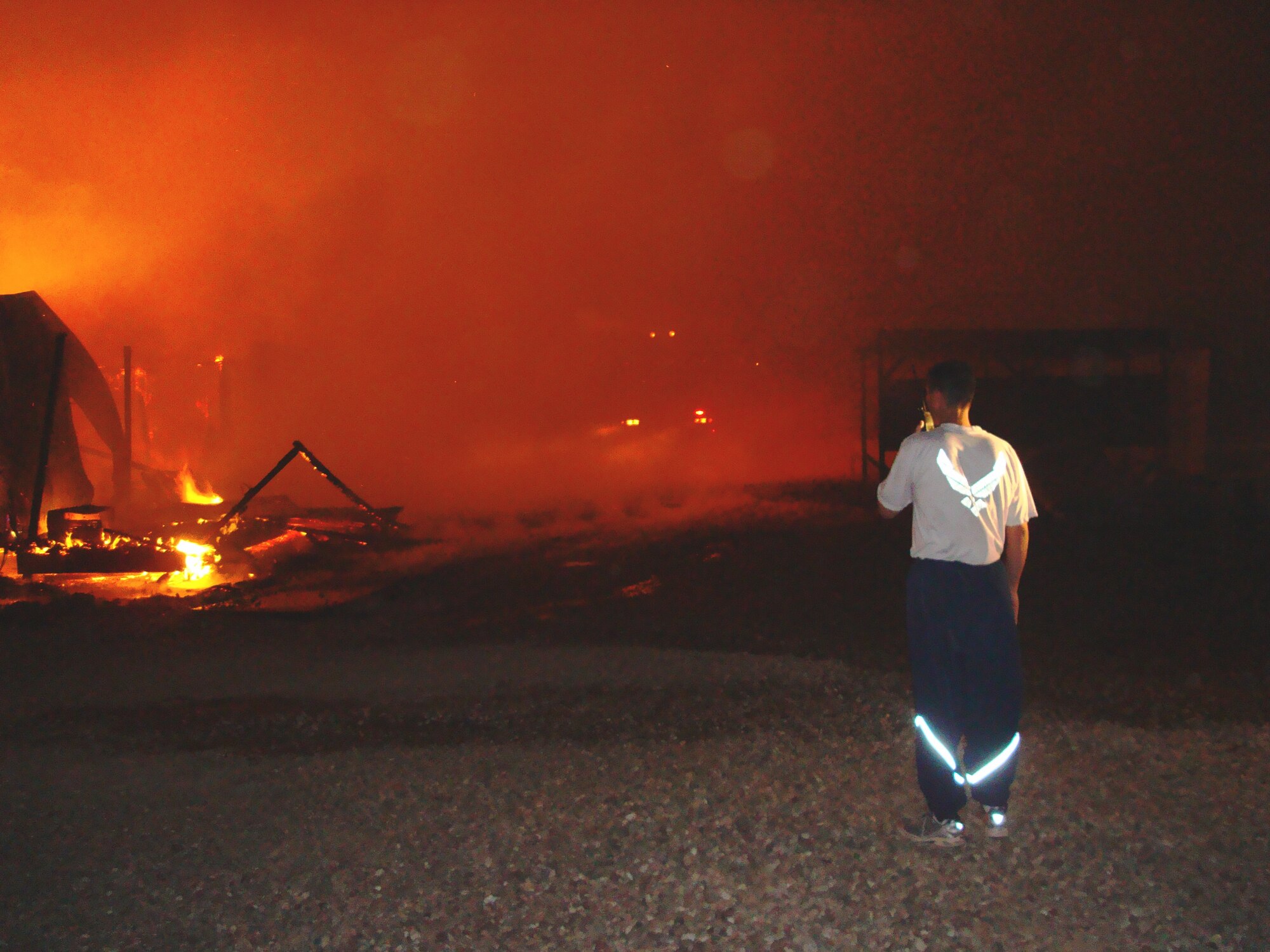 JOINT BASE BALAD, Iraq -- Chief Master Sgt. Michael Rosser, Joint Base Balad fire chief, conducts size-up and strategy development at the site of the Aviation Village housing area fire. Chief Rosser served as the incident commander and saved 60 nearby structures from the flames. (Courtesy photo)