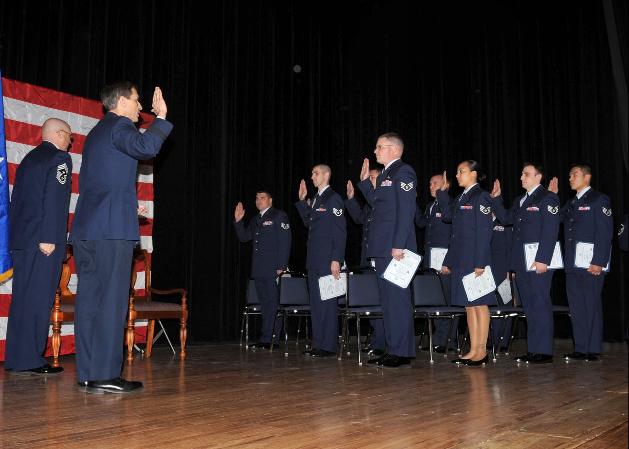 Brig. Gen. Paul Johnson, 355th Fighter Wing commander, administers the oath of enlistment to Davis-Monthan's newest staff sergeants during an NCO Induction Ceremony at the base theater Jan. 4. This ceremony, held monthly, recognizes the base's newest non-commissioned officers. (U.S. Air Force photo/Airman Jerilyn Quintanilla)
