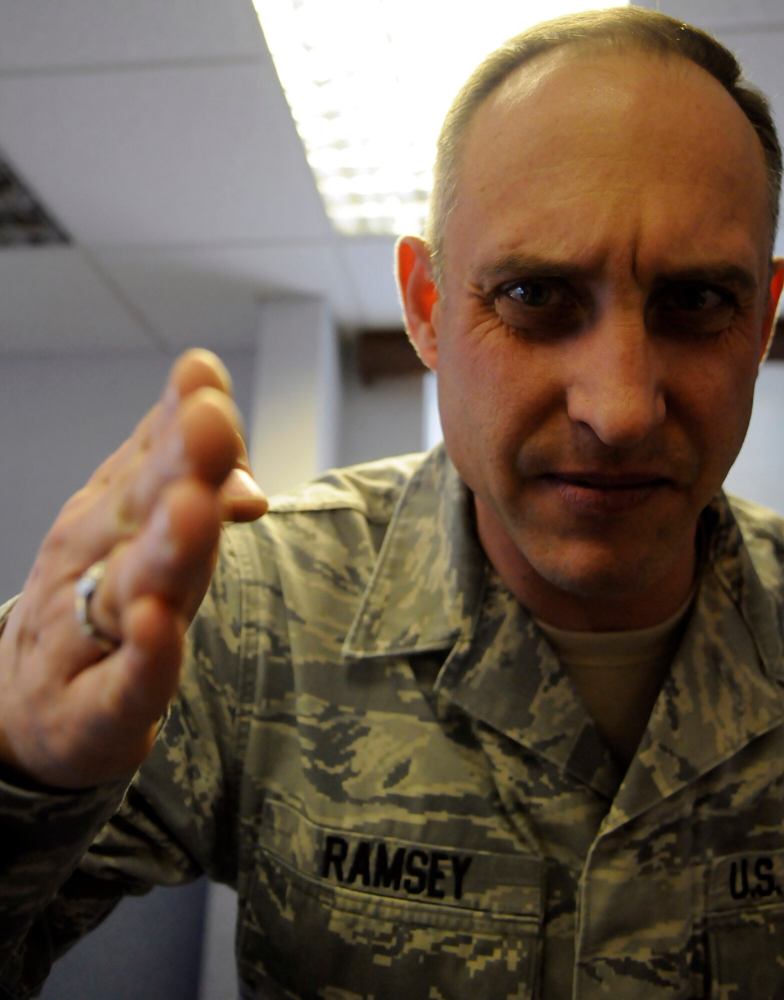 First Sergeant says "All Airmen must salute during 'God Save the Queen!'" Senior Master Sgt. Todd Ramsey is not alone with this thought. According to Air Force Manual 36-2203, flags and national anthems of friendly foreign countries are shown the same marks of respect as those of the U.S. When outdoors, Airmen should come to attention, face the flag if visible (or the music) and salute. When indoors, face the flag or music and assume the position of attention. Do not salute unless under arms. When in civilian clothing outdoors, take the same action as when in uniform, but use the following manner of saluting. Men remove the headdress with the right hand and hold it at the left shoulder with the right hand over the heart. Men without hats and women salute by standing at attention and placing the right hand over the heart. When in civilian clothing indoors, render the civilian salute by standing at attention and placing the right hand over the heart.  (U.S. Air Force illustrative photo/Tech. Sgt. Kevin Wallace, Staff Sgt. Christopher L. Ingersoll)