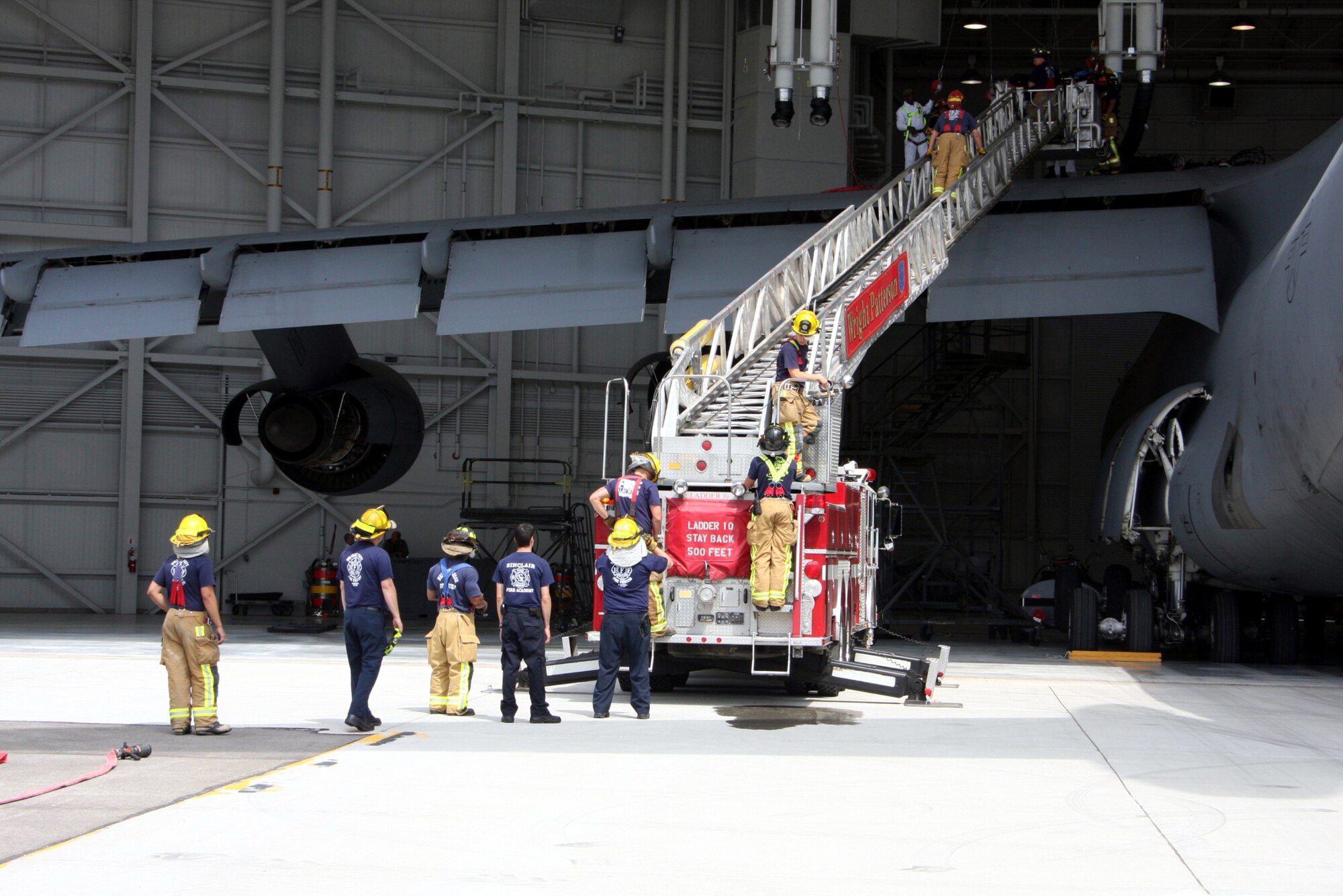 WRIGHT-PATTERSON AIR FORCE BASE, Ohio – Firefighters from the 445th Airlift Wing prepare to run through a training scenario involving a C-5 Galaxy aircraft.  The firefighters continuously train for all possible scenarios that may arise at the wing or an incident they may have to respond to. (U.S. Air Force photo/Senior Airman Mikhail Berlin)
