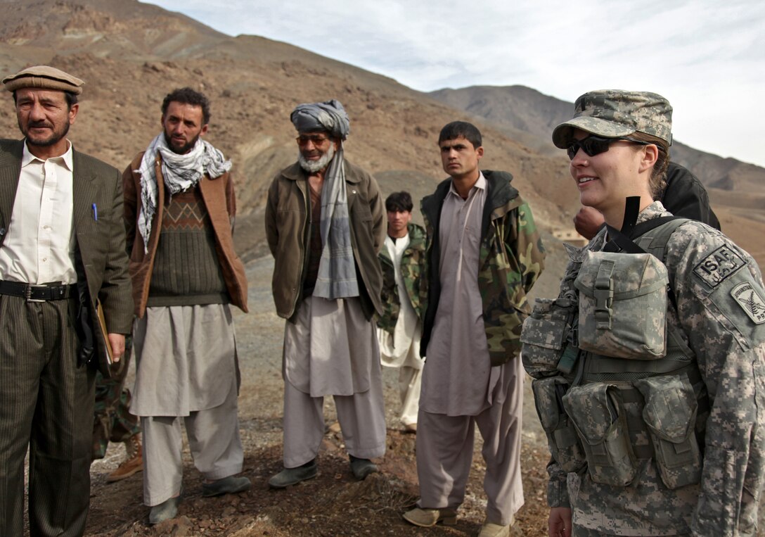 U.S. Air Force 1st Lt. Kathryn Miles, Shah Murza, a representative from the Afghan Minister of Agriculture, and Panjshir Provincial Reconstruction Team members meet with Afghan locals on a hilltop in the Anaba district of Panjshir province, Afghanistan, Jan. 2, 2010. Miles is an engineer and also a member of the provincial team, which is surveying a possible location for a water reservoir.

