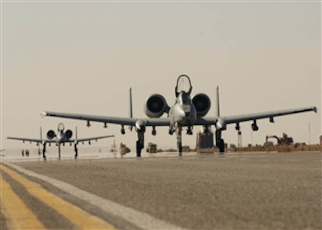 Two U.S. Air Force A-10C Thunderbolt II aircraft from the 354th Expeditionary Fighter Squadron taxi at Kandahar Airfield, Afghanistan, on Jan. 1, 2010.  Airmen from the 354th Expeditionary Fighter Squadron have logged more than 10,000 flight hours and 2,500 sorties during their six-month tour in Afghanistan.  