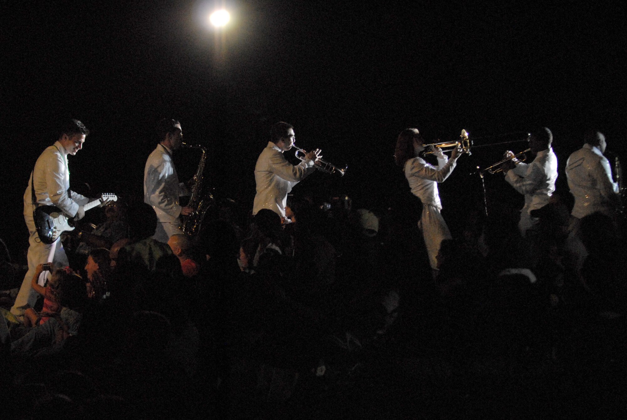 HICKAM AIR FORCE BASE, Hawaii - Members of Tops In Blue perform within a crowd of audience members during a Tops In Blue performanc here, Jan. 5. Tops In Blue is an expeditionary entertainment unit that primarly performs for those stationed worldwide at remote and deployed locations. (U.S. Air Force photo/Senior Airman Gustavo Gonzalez)