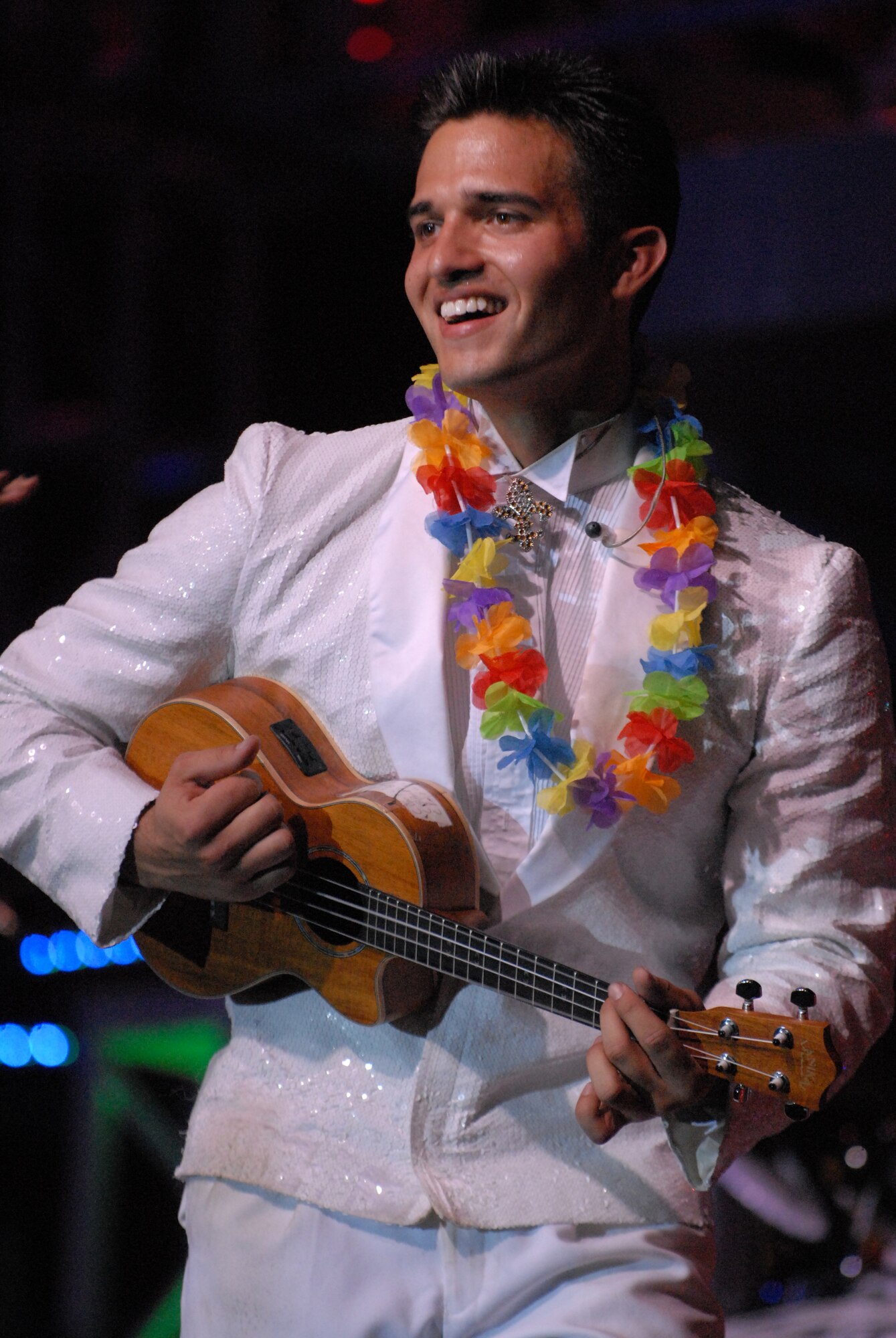 HICKAM AIR FORCE BASE, Hawaii - Airman 1st Class Shane Jones, Tops In Blue guitarist assigned to the 15th Communications Squadron, plays the ukelele during a Tops In Blue performance here, Jan. 5. Tops In Blue is an expeditionary entertainment unit that primarly performs for those stationed worldwide at remote and deployed locations. (U.S. Air Force photo/Senior Airman Gustavo Gonzalez)
