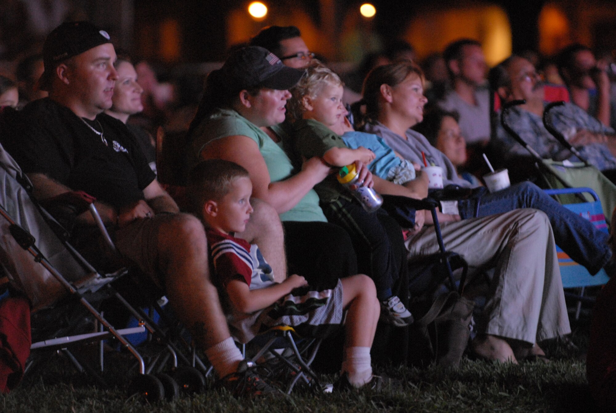 HICKAM AIR FORCE BASE, Hawaii - Audience members watch as Tops In Blue perform here, Jan. 5. Tops In Blue is an expeditionary entertainment unit that primarly performs for those stationed worldwide at remote and deployed locations. (U.S. Air Force photo/Senior Airman Gustavo Gonzalez)