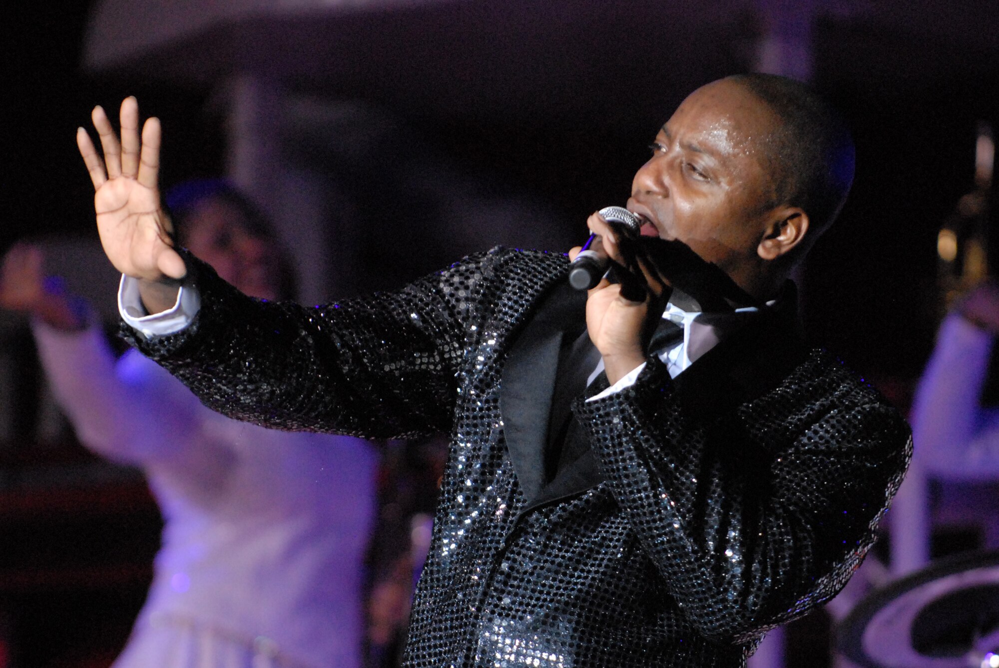 HICKAM AIR FORCE BASE, Hawaii - Tech Sgt. Octavious Hill, Tops In Blue vocalist, sings during a performance here Jan. 5. Tops In Blue is an expeditionary entertainment unit that primarly performs for those stationed worldwide at remote and deployed locations. (U.S. Air Force photo/Senior Airman Gustavo Gonzalez)