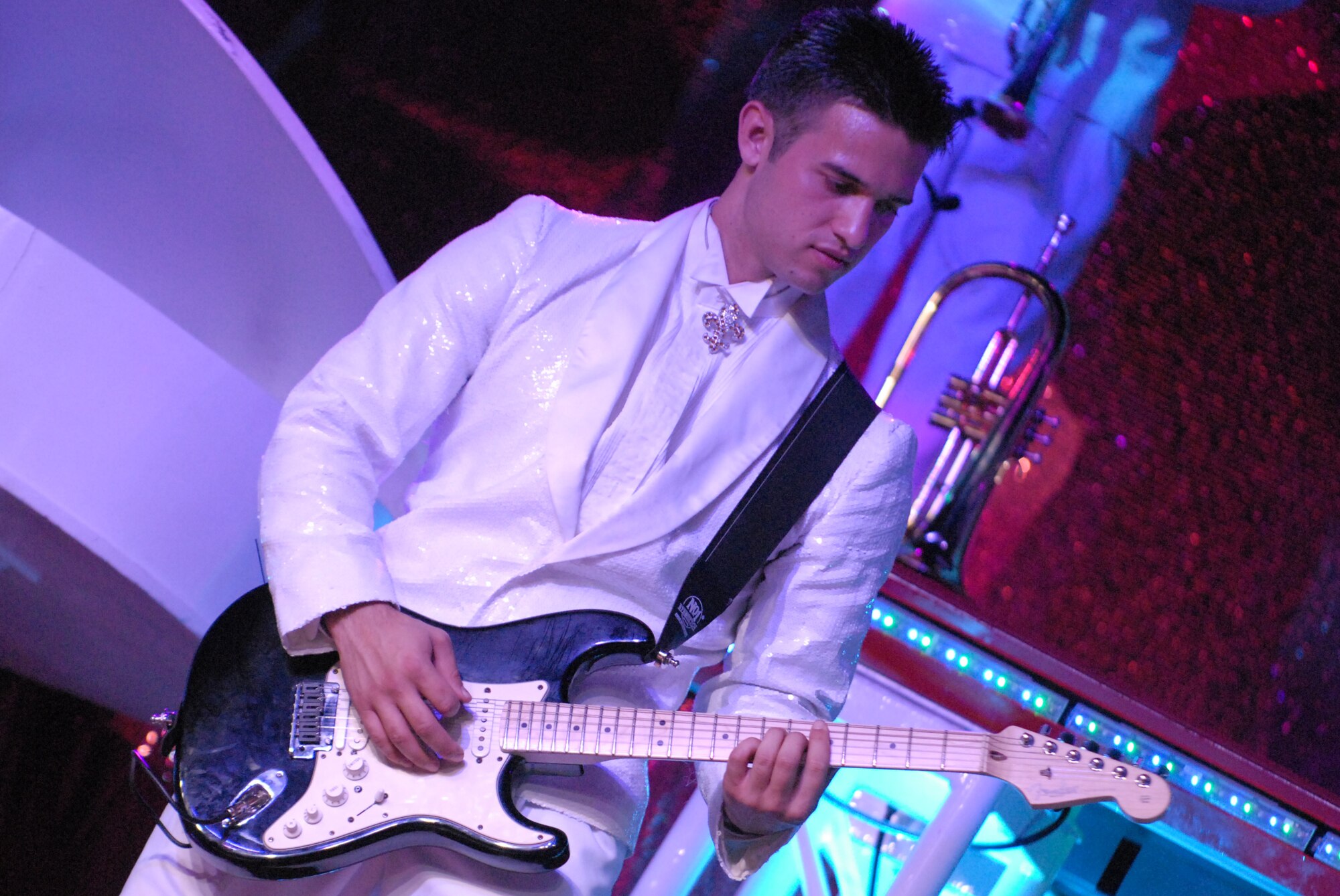 HICKAM AIR FORCE BASE, Hawaii - Airman 1st Class Shane Jones, Tops In Blue guitarist assigned to the 15th Communications Squadron, plays the guitar during a Tops In Blue performance here, Jan. 5. Tops In Blue is an expeditionary entertainment unit that primarly performs for those stationed worldwide at remote and deployed locations. (U.S. Air Force photo/Senior Airman Gustavo Gonzalez)