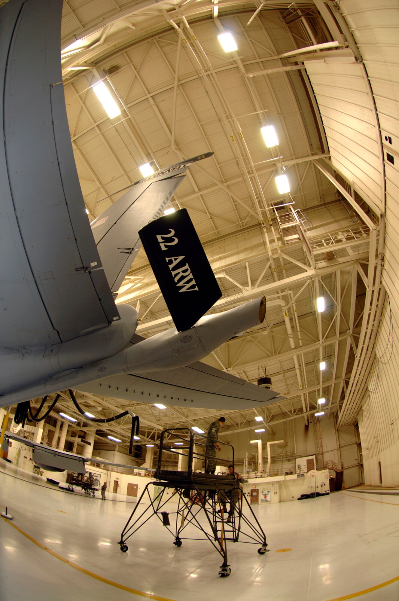 Aircraft maintenance Airmen work under high bay fluorescent lighting, Jan. 5, 2009, at McConnell Air Force Base, Kan. In an effort to meet new government energy conservation expectations, the base is currently testing and installing more energy efficient resources such as brighter, energy-saving lights in aircraft hangars. (U.S. Air Force photo/Senior Airman Jessica Lockoski) 
