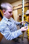 MINOT AIR FORCE BASE, N.D. -- Airman 1st Class Shelton Feibel, 5th Civil Engineer Squadron draftsman, ensures the GPS survey equipment is functioning properly here Jan. 6. The GPS survey equipment connects with the base station to give exact location and elevation for projects on base. (U.S. Air Force photo by Senior Airman Sharida Jackson)