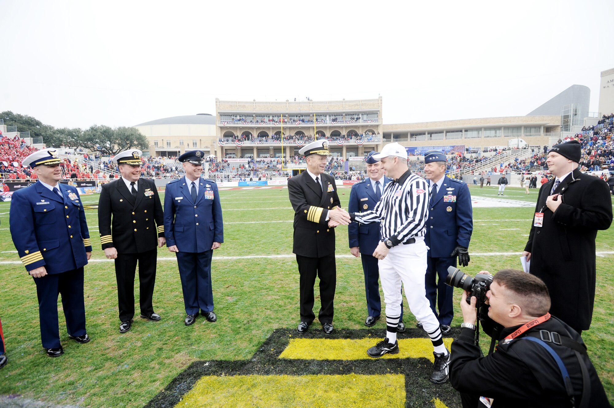 Adm. Mike Mullen, chairman of the Joint Chiefs of Staff, greets the referee Dec. 31, 2009, prior to the coin toss for the Armed Forces Bowl game between the U.S. Air Force Academy and the University of Houston.  Observing are Gen. Howie Chandler (beside Admiral Mullen), Air Force vice chief of staff, and Lt. Gen. Mike Gould (behind referee), superintendent of the Air Force Academy.  The Falcons went on to defeat the Cougars 41-20.  (U.S. Air Force photo/Bill Evans)