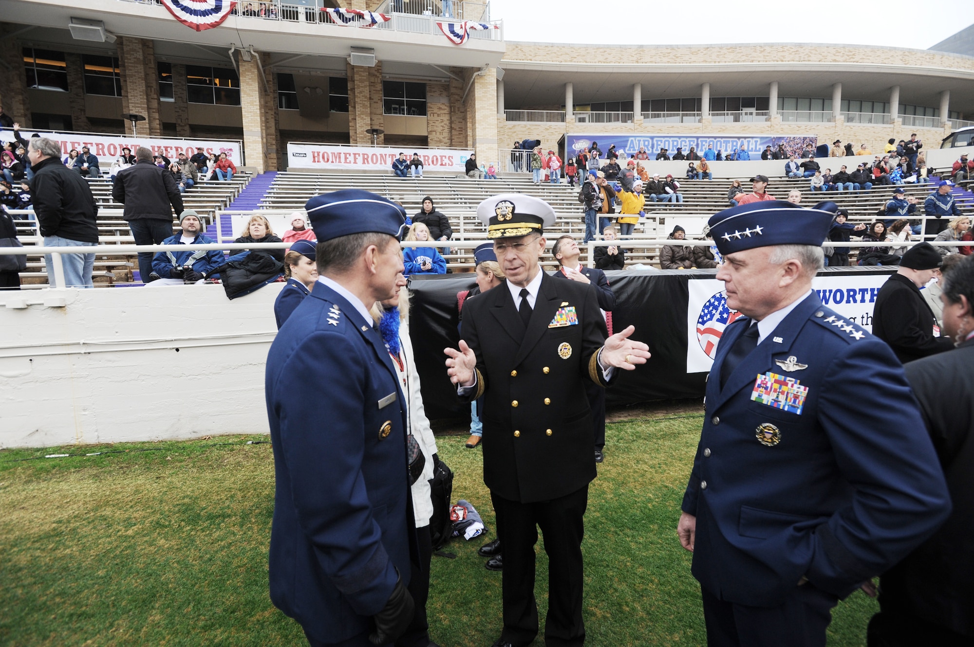 Adm. Mike Mullen, chairman of the Joint Chiefs of Staff, chats with Gen. Howie Chandler (right), Air Force vice chief of staff, and Lt. Gen. Mike Gould, superintendent of the Air Force Academy, and his wife Paula Dec. 21, 2009, right before the Armed Forces Bowl kickoff in Fort Worth, Texas.  The Air Force Academy Falcons triumphed over the University of Houston Cougars, 41-20. (U.S. Air Force photo/Bill Evans)