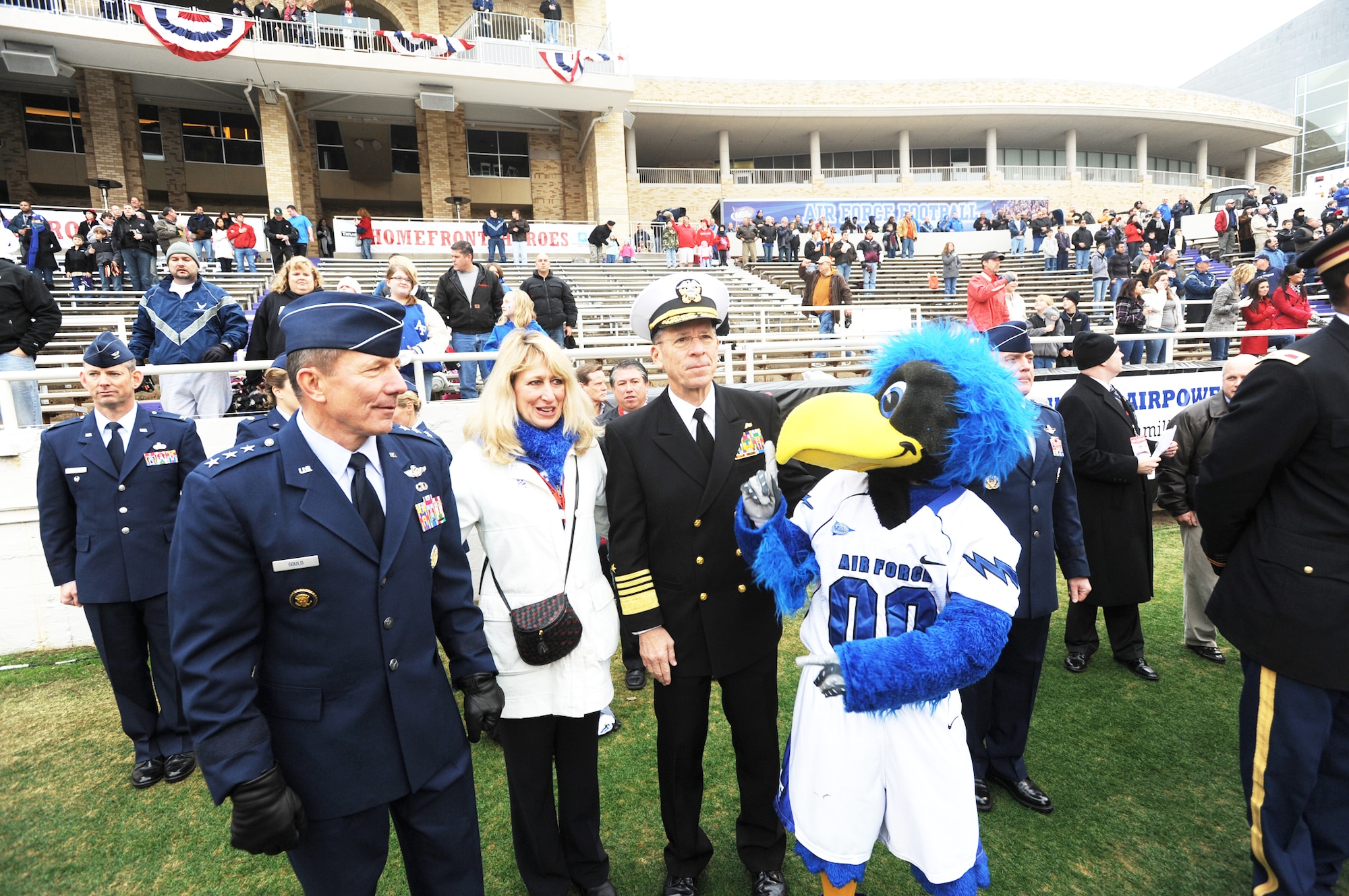 Lt. Gen. Mike Gould, superintendent of the Air Force Academy, and his wife Paula, along with Adm. Mike Mullen, chairman of the Joint Chiefs of Staff, enjoy a visit from the Academy's never-bashful mascot, The Bird, Dec. 31, 2009, right before the Armed Forces Bowl kickoff in Fort Worth, Texas.  The Air Force Academy Falcons triumphed over the University of Houston Cougars, 41-20. (U.S. Air Force photo/Bill Evans)