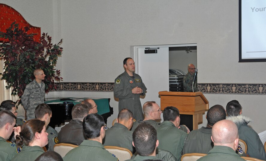 MINOT AIR FORCE BASE, N.D. -- Lt. Col. Douglas Warnock, 5th Bomb Wing chief of safety, briefs members from the 5th Operations Group during Wingman Safety Day at the Jimmy Doolittle Center here Dec. 4. Wingman Safety day was used to put safety in the forefront of every Airman's mind and it provides wing leadership, commanders, and supervisors at all levels an opportunity to remind Airmen and their teams to ensure everyone has a safe plan for the new year. (U.S. Air Force photo by Senior Airman Michael J. Veloz)