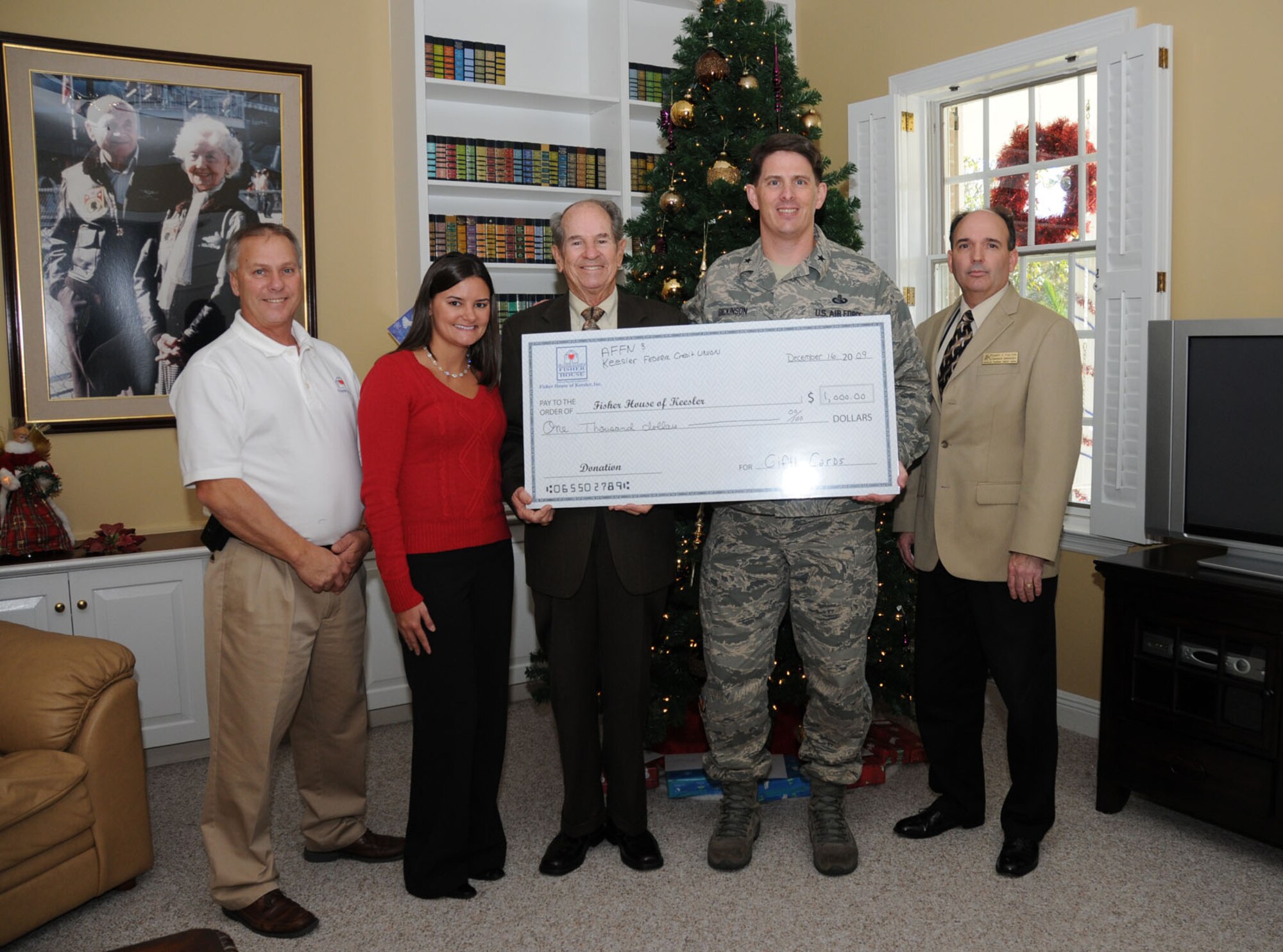 Keesler Federal Credit Union and the Armed Forces recently donated $1,000 in commissary gift cards to Keesler's Fisher House Dec. 16.  Fisher House provides a comfortable home-away-from-home for families of seriously ill patients at Keesler Medical Center and the Biloxi Veterans Administration Medical Center. On hand for the presentation were (from left) Larry Vetter, Fisher House director; Jessica Bartels, KFCU head of marketing; Tommy Atkins, president of KFCU board of directors; Brig. Gen. Ian Dickinson, 81st Training Wing commander; and Gary Fulton, manager of KFCU's Larcher Branch.  (U.S. Air Force photo by Kemberly Groue)
