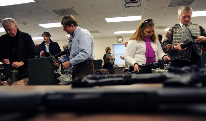 Honorary commanders inspect issued equipment on their tables at the Combat Arms Training and Maintenance facility here Jan. 5. The commanders participated in weapons training with combat arms instructors as part of their induction as honorary commanders. (U.S. Air Force photo/Senior Airman Katie Gieratz)(RELEASED)
