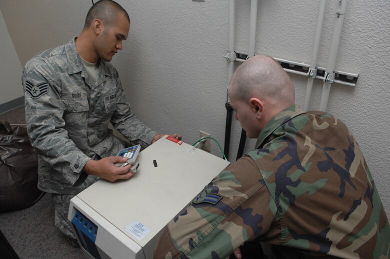 MINOT AIR FORCE BASE, N.D. -- Staff Sergeant Blayne Souza, 5th Communications Squadron and Airman 1st Class Christopher Mills, perform back up battery tests during a previous Nuclear Surety Inspection here in 2009. An NSI is designed to evaluate a unit's readiness to execute nuclear operations. (U.S. Air Force photo by Staff Sergeant Stacy Moless)