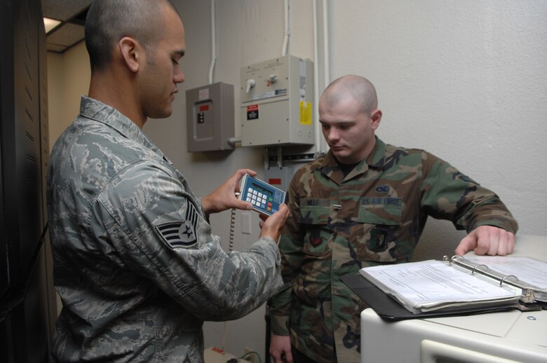 MINOT AIR FORCE BASE, N.D. -- Staff Sergeant Blayne Souza, 5th Communications Squadron and Airman 1st Class Christopher Mills, perform back up battery tests during a previous Nuclear Surety Inspection here in 2009. An NSI is designed to evaluate a unit's readiness to execute nuclear operations. (U.S. Air Force photo by Staff Sergeant Stacy Moless)