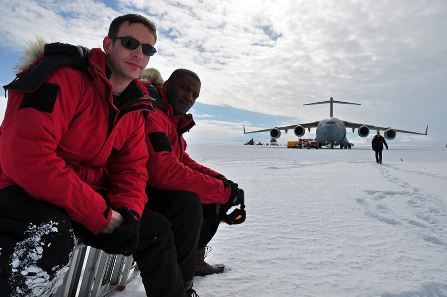 Staff sergeants Joshua Clark and Nathedus Kittles, both 62nd Aircraft Maintenance Squadron crew chiefs, pose for a picture on the ice at Pegasus Field, Antarctica. Each season, Team McChord Airmen support Operation Deep Freeze, the Defense Department’s logistical support to research activities in Antarctica. (U.S. Air Force photo/Staff Sgt. Robert Tingle)