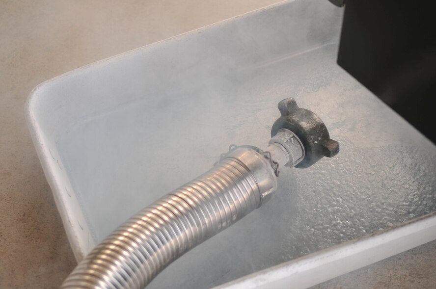 Liquid oxygen drains into an overflow container on Seymour Johnson Air Force Base, N.C., Jan. 5, 2010. Liquid oxygen is kept at negative 298 degrees Fahrenheit. At that temperature, liquid oxygen can cause things to freeze in a matter of seconds making, the objects extremely brittle. (U.S. Air Force photo/Airman 1st Class Rae Perry)