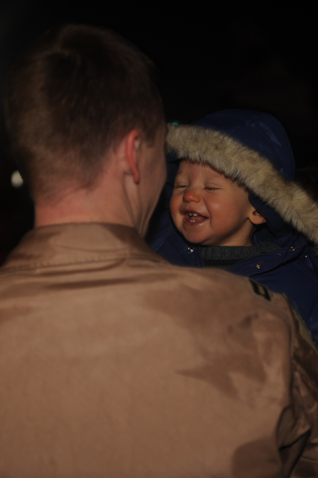 Capt. Joe Elam, 335th Fighter Squadron aircrew, holds his son Andrew, after returning home from a four-month deployment on Seymour Johnson Air Force Base, N.C., Jan. 5, 2010. Captain Elam deployed to Bagram Airfield, Afghanistan, in support of Operation Enduring Freedom. (U.S. Air Force photo/Senior Airman Ciara Wymbs)