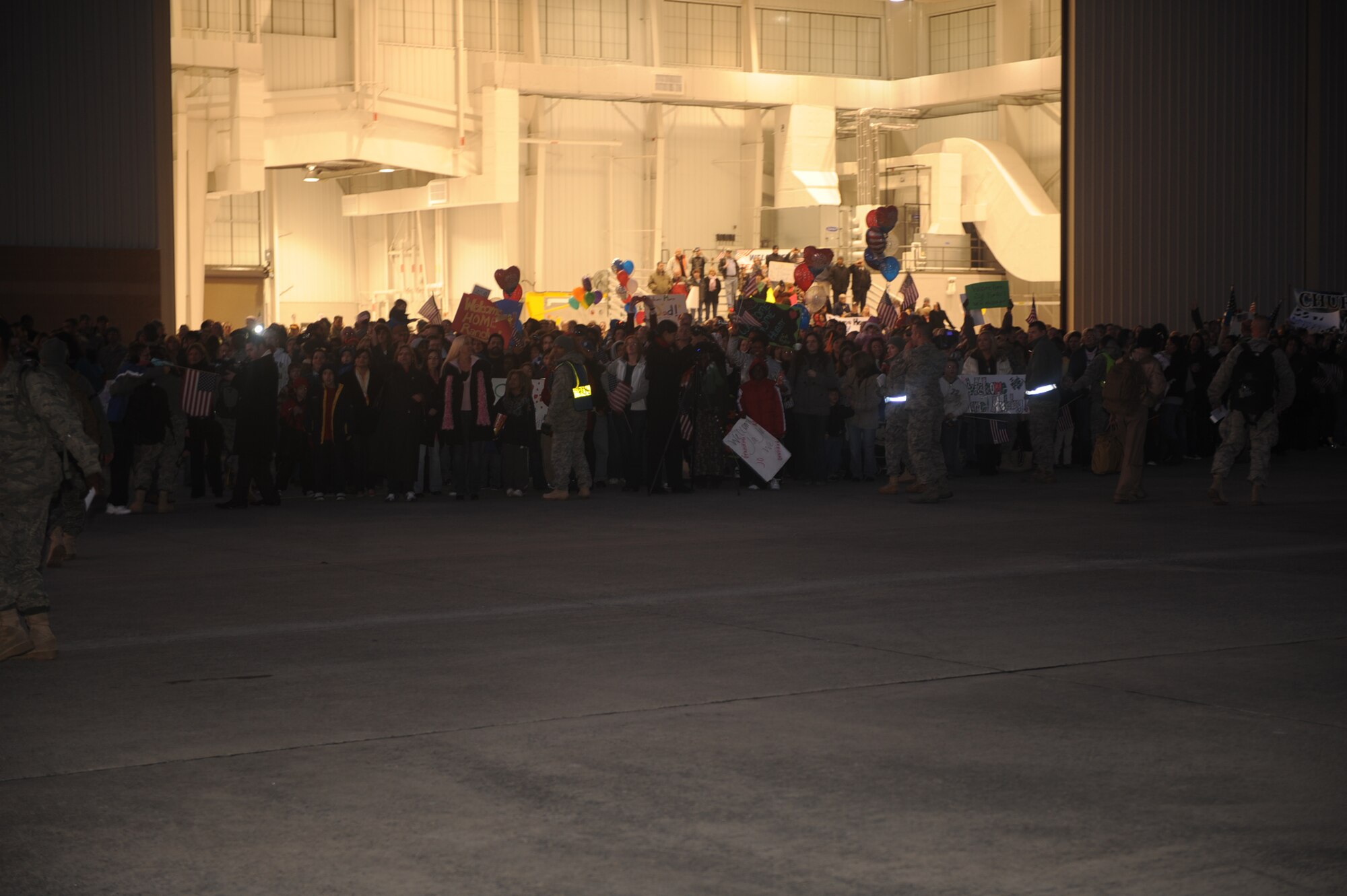 Families of Airmen from the 335th Aircraft Maintenance Unit and 335th Fighter Squadron await the arrival of their loved ones at Seymour Johnson Air Force Base, N.C., Jan. 5, 2010. The Airmen deployed to Afghanistan in support of Operation Enduring Freedom. (U.S. Air Force photo/Senior Airman Ciara Wymbs) 