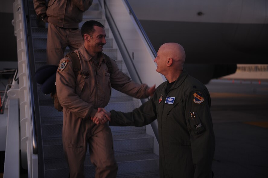Lt. Col. Lance Bunch, 4th Operations Group deputy commander, greets Airmen as they depart an aircraft after returning from a four-month deployment to Afghanistan on Seymour Johnson Air Force Base, N.C., Jan. 5, 2010. The Airmen relieved the 336th Aircraft Maintenance Unit and 336th Fighter Squadron in September for the last Seymour Johnson fighter squadron deployment of 2009. (U.S. Air Force photo/Senior Airman Ciara Wymbs) 