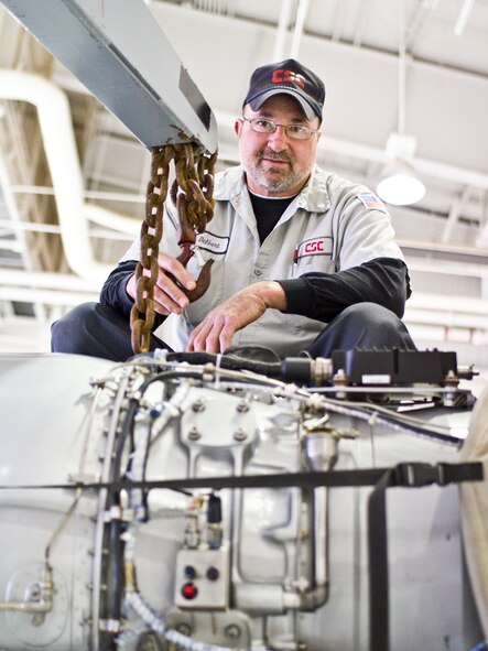 Delbert Mavity, senior aircraft mechanic, sits on top of a T-1A Jayhawk to attach the engine hoist to the engine as he did on Dec. 1 during a routine engine removal. (U.S. Air Force photo/2nd Lt. Paul Whittaker)