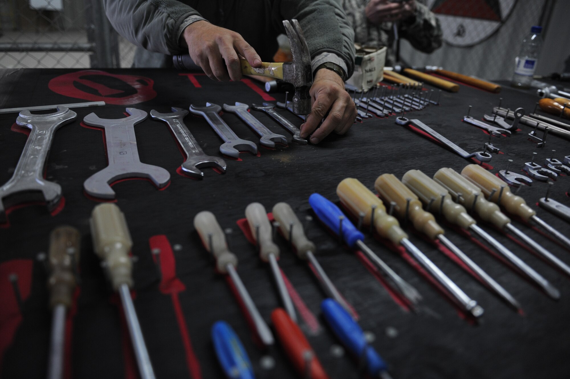 Tech. Sgt. John Ellis, a 738th Air Expeditionary Maintenance advisor, sets up a tool accountability mat for a tool room at Kandahar Airfield, Afghanistan, Jan. 5, 2010.  AEM airmen are helping Afghanistan National Army Air Corps soldiers perform maintenance functions on MI-17 helicopters. Sergeant Ellis is deployed from Seymour-Johnson AFB, N.C.  (U.S. Air Force photo/Staff Sgt. Manuel J. Martinez/Released)