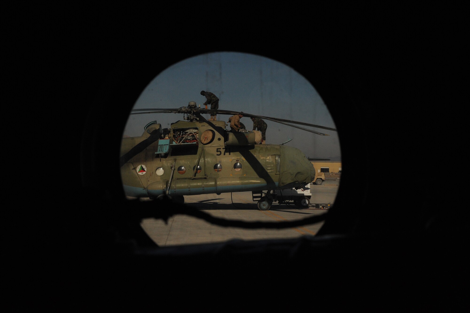 Afghanistan National Army Air Corps soldiers perform routine maintenance on an MI-17 helicopter at Kandahar Airfield, Afghanistan, Jan. 5, 2010. Airmen attached to the 738th Air Expeditionary Advisor Group provide maintenance mentorship for ANAAC Soldiers.  (U.S. Air Force photo/Staff Sgt. Manuel J. Martinez/Released) 