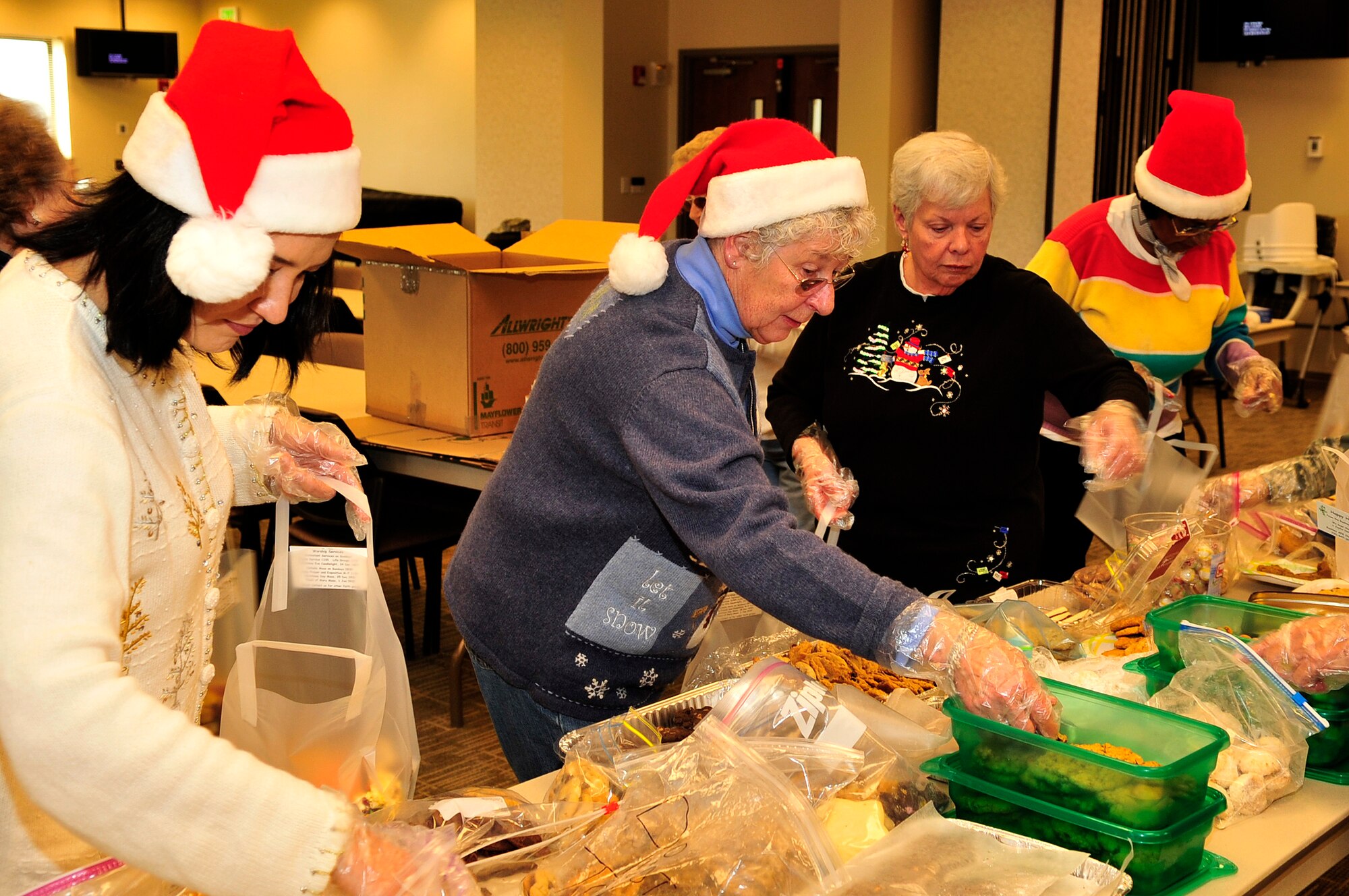 BUCKLEY AIR FORCE BASE, Colo. -- Volunteers Ann Wheless, Barb Ciesluk, Joyce Langer and Ann Burgess aid in bagging cookies for the annual cookie caper at the base chapel Dec. 15, 2009. 154 dozen bags were made and delivered to dorm residents. (U.S. Air Force Photo by Airman 1st Class Manisha Vasquez) 