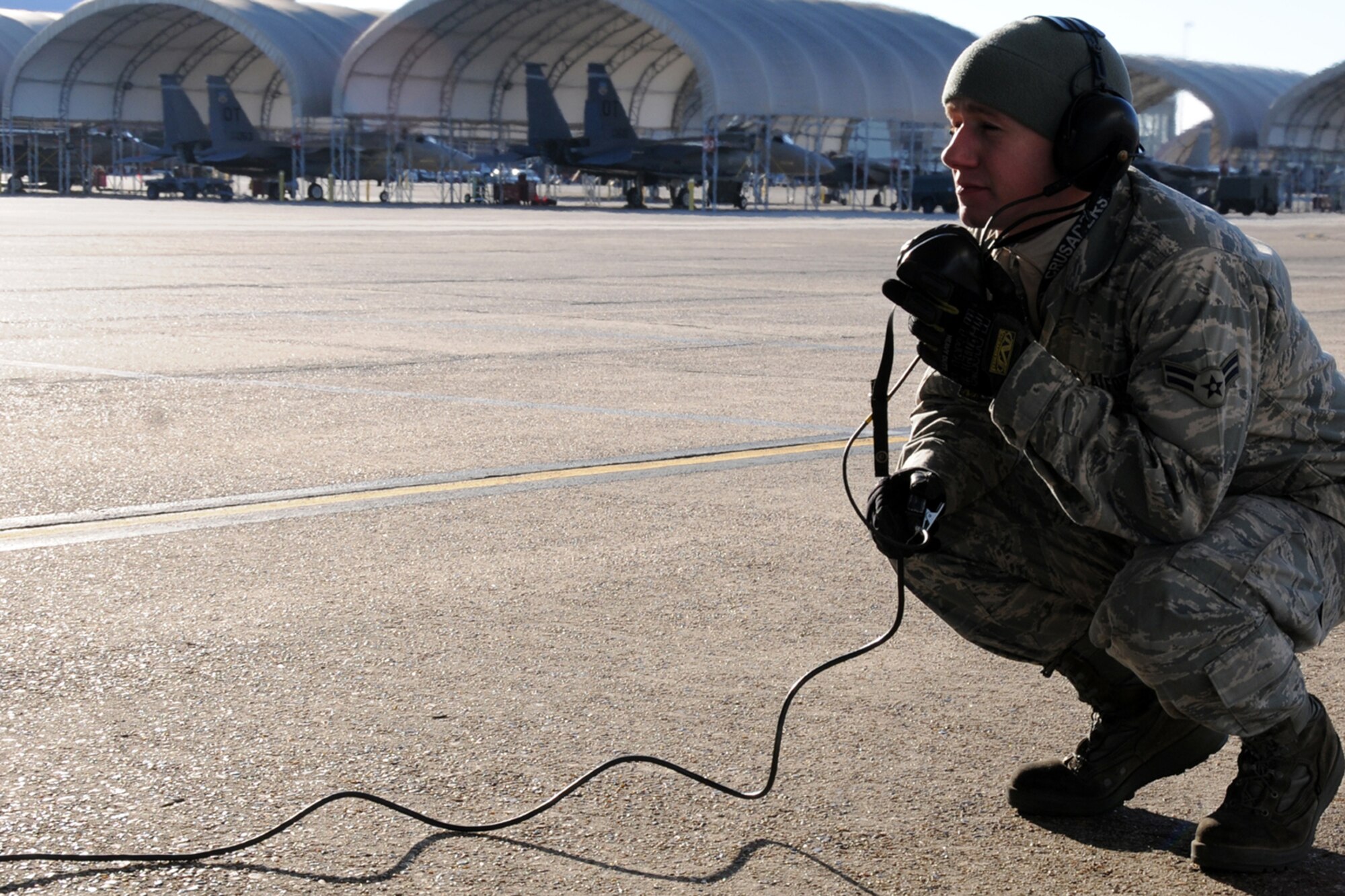 EGLIN AIR FORCE BASE, Fla. -- Airman 1st Class Travis Young, 46th Aircraft Maintenance Squadron, begins communicating with the pilot of an F-16 before it taxis to the runway. Northwest Florida was hit by a massive cold front sending temperatures plummeting well below freezing. Despite the cold, the maintainers must prepare the jets and get them in the air. (U.S. Air Force photo/Airman 1st Class Anthony Jennings)