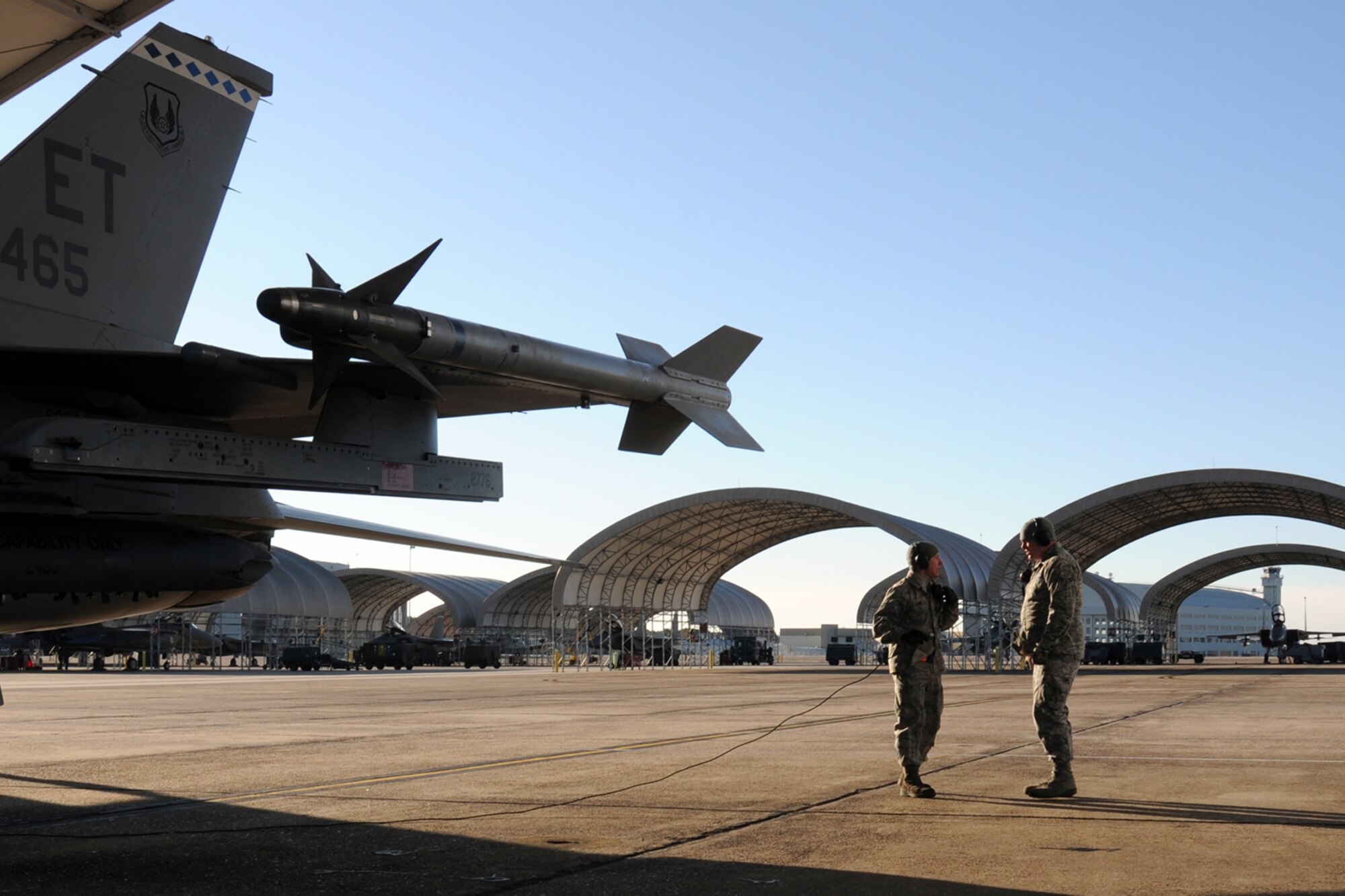 EGLIN AIR FORCE BASE, Fla. – Airman 1st Class Cody Snodgrass and Travis Young, 46th Aircraft Maintenance Squadron, talk while waiting for an F-16’s engine to fire up Jan. 5. Northwest Florida was hit by a massive cold front sending temperatures plummeting well below freezing. Despite the cold, the maintainers must prepare the jets and get them in the air. (U.S. Air Force photo/Airman 1st Class Anthony Jennings)