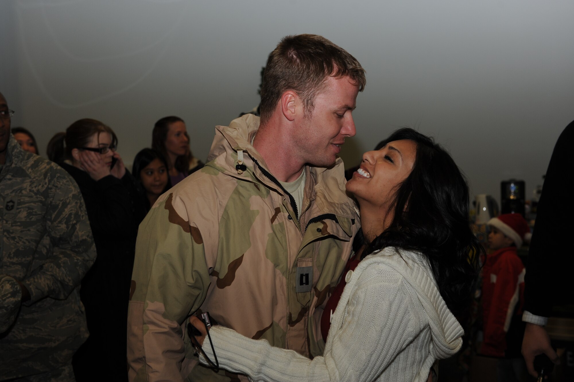 Capt. Jason Robinson, a 53rd Airlift Squadron pilot, is greeted on his return from deployment by his wife, Mary Ann, Dec. 25 at Building 430. The Captain was one of nearly 160 who returned home Christmas Day. (U.S. Air Force photo by Senior Airman Ethan Morgan)