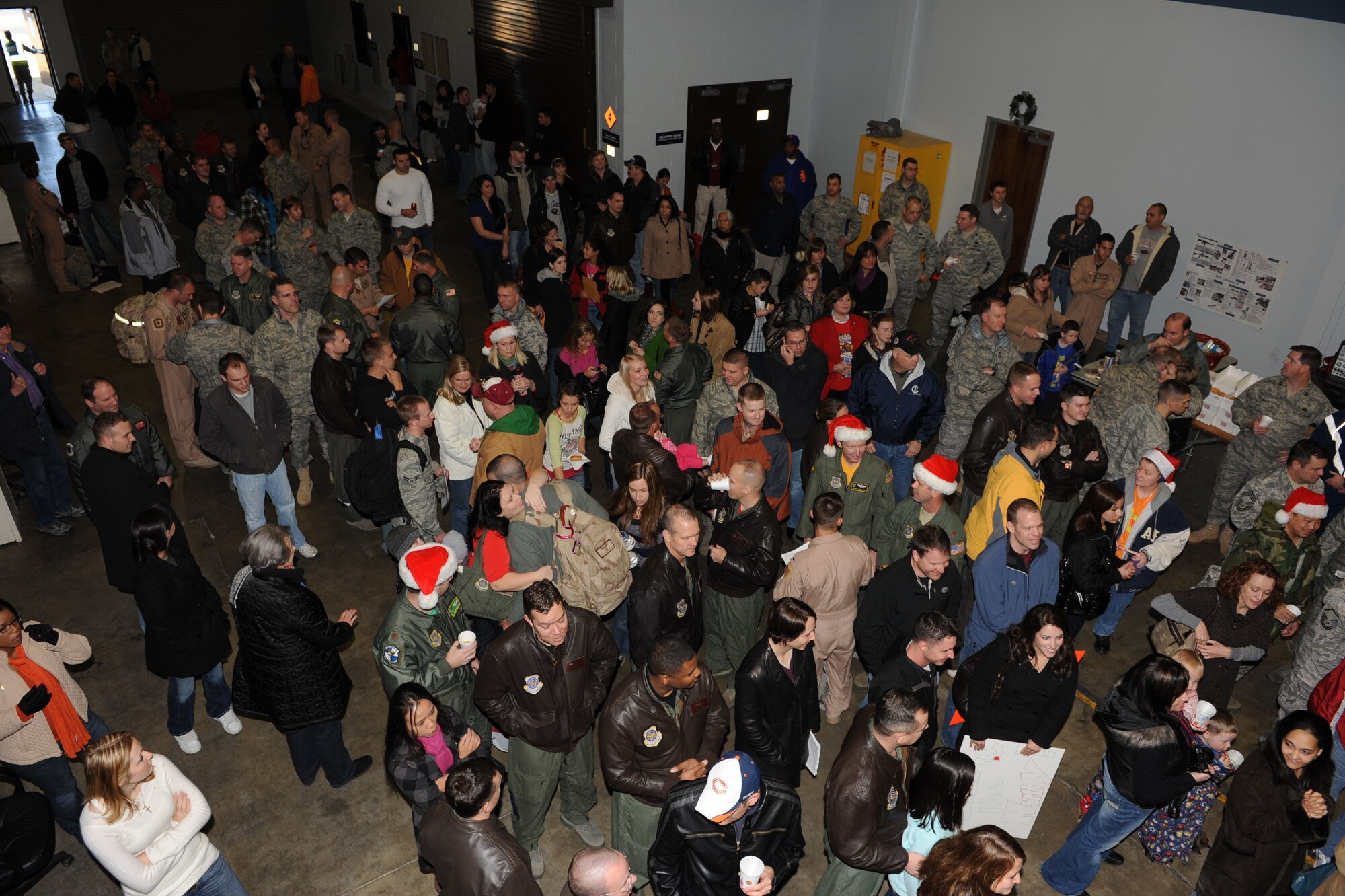 Friends, families and co-workers came together to welcome back their friends and loved ones from a deployment Dec. 25 at Bldg. 430. Nearly 160 Airmen returned home Christmas Day. (U.S. Air Force photo by Senior Airman Ethan Morgan)