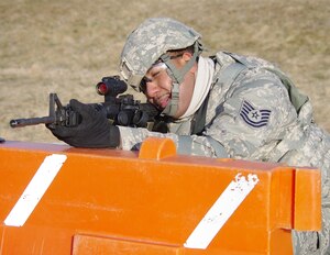 CAMP ATTERBURY, Ind. -- Tech. Sgt. Jeffery Benjamin, deployed from the 15th Intelligence Squadron at Langley Air Force Base, Va., fires live rounds during a stress shoot training event. The stress shoot is one of many required tasks at pre-deployment training.  Benjamin and other members of Provincial Reconstruction Team Panjshir, who are deployed from various Air Force bases and Army posts, are attending the training at Camp Atterbury in preparation to move forward to the Panjshir Province in Afghanistan. Once in Afghanistan, the team will spend almost a year promoting local governance in the region. (U.S. Air Force photo by Army Sgt. Matthew Ryan)