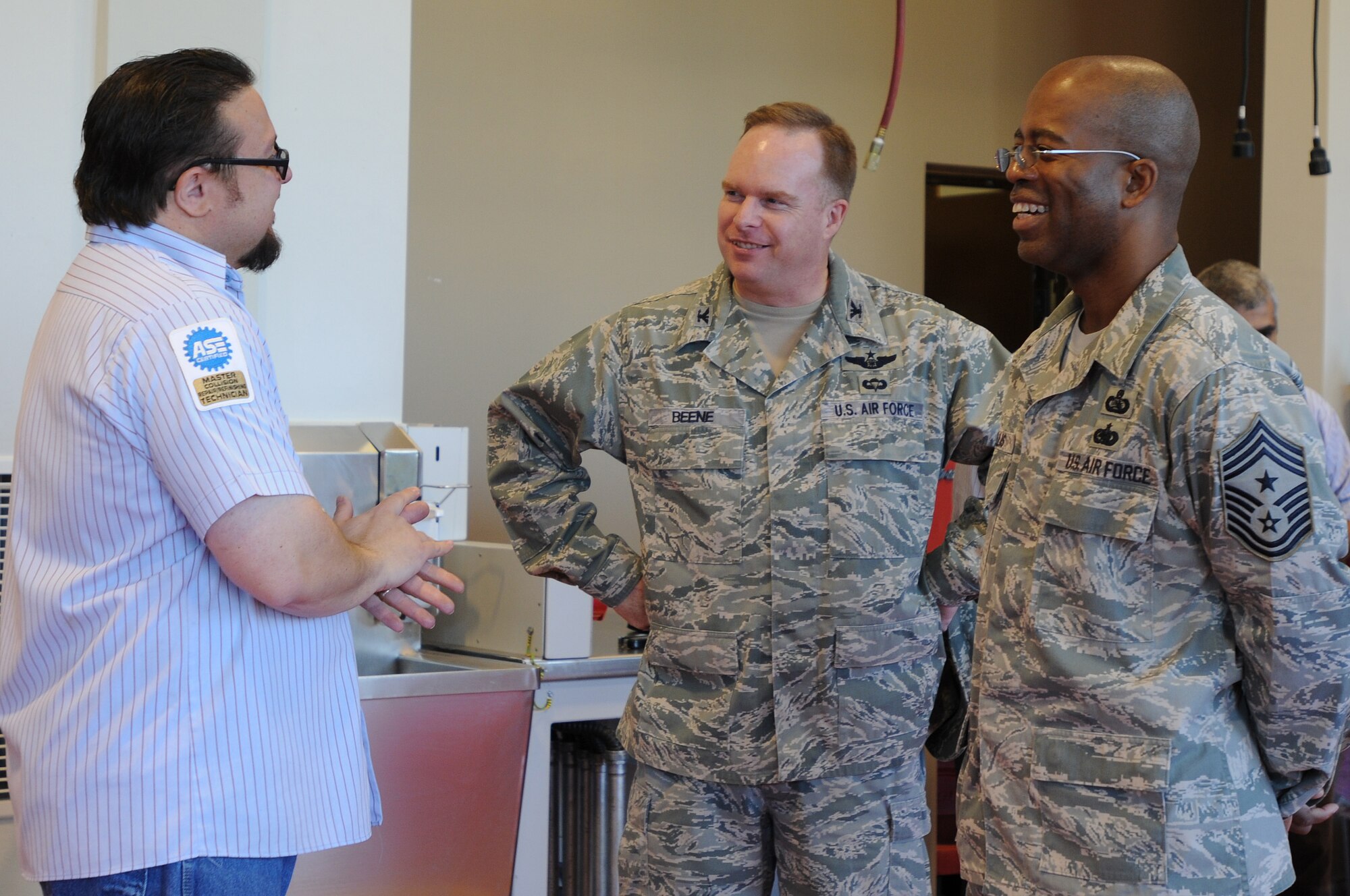 Col. Eric Beene, the 39th Air Base Wing commander, and Chief Master Sgt. Robert Ellis, the 39th ABW command chief, talks to Tony DeMarco, the Auto Hobby Shop manager, about the new facility Tuesday, Jan. 5, 2010 at Incirlik Air Base.  Construction of the new auto hobby shop took nearly one year to complete.  (U.S. Air Force photo/Senior Airman Ashley Wood)