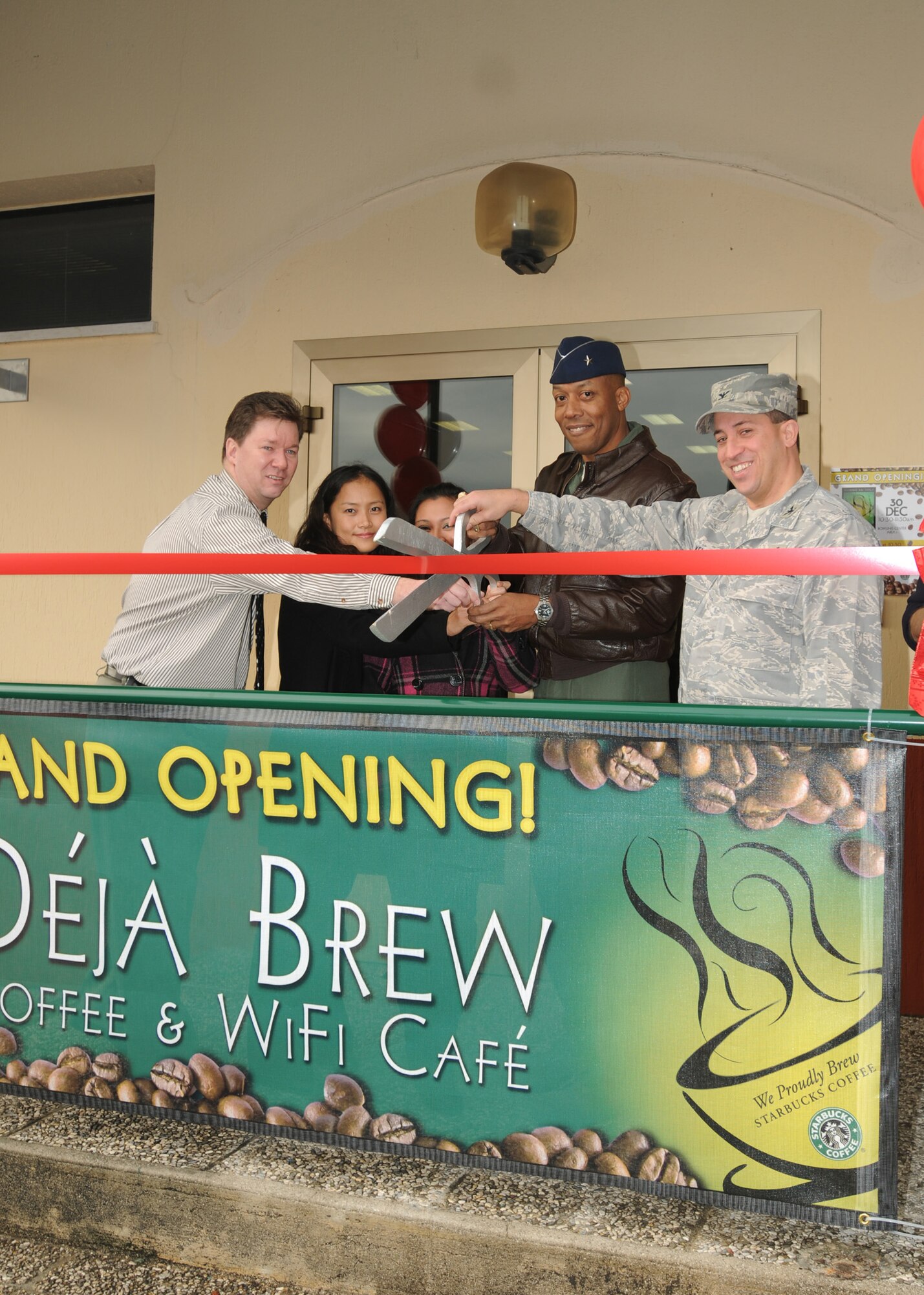 Brig. Gen. C.Q. Brown Jr. 31st Fighter Wing commander and Col. Brian Kelly, 31st Mission Support Group commander, and members of the 31st Force Support Squadron, cut a ribbon during the Dec. 30, 2009 grand opening ceremony of the Deja Brew Coffee and Wireless Internet Cafe.  The new cafe, located next to the Bowling Center in Area 1 of Aviano Air Base, Italy, seats up to 30 people and serves coffee, cheesecake, snacks, and assorted frozen drinks (caffeinated and non-caffeinated such as mango frozen drinks).  The cafe is open 6 a.m. to 5 p.m. Monday, 6 a.m. to 6 p.m. Tuesday thru Friday and 11 a.m. to 5 p.m. Saturday and Sunday.  (U.S Air Force photo/Airman LaVel D. Sterling)