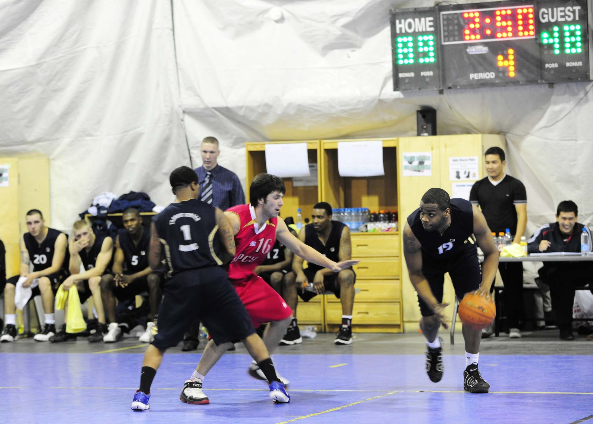 Senior Airman Christopher Williams uses teammate Brandon Boswell to set up a screen and get around a Kyrgyz Russian Slavic University defender during a basketball game here Jan. 5. Airman Williams is a 376th Expeditionary Security Forces Squadron security journeyman, and Boswell is a communications security contractor with the 376th Expeditionary Communications Squadron. The Transit Center at Manas team defeated the KRSU team 93-51. (U.S. Air Force photo by Senior Airman Nichelle Anderson)
