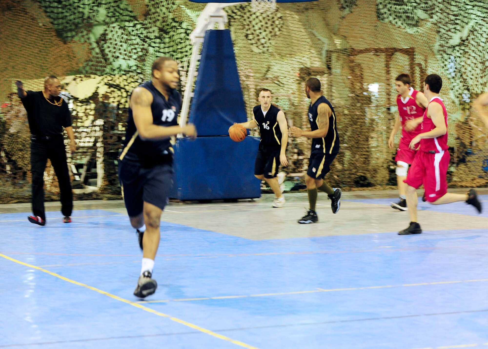 Senior Airman Roy Zellmer, guard, dribbles the ball down the court during a game here Jan. 5 against students from the Kyrgyz Russian Slavic University. He is a 376th Expeditionary Security Forces Squadron armorer. The Manas team hosted a friendly match to build camaraderie between the local community and the Transit Center. (U.S. Air Force photo by Senior Airman Nichelle Anderson)
