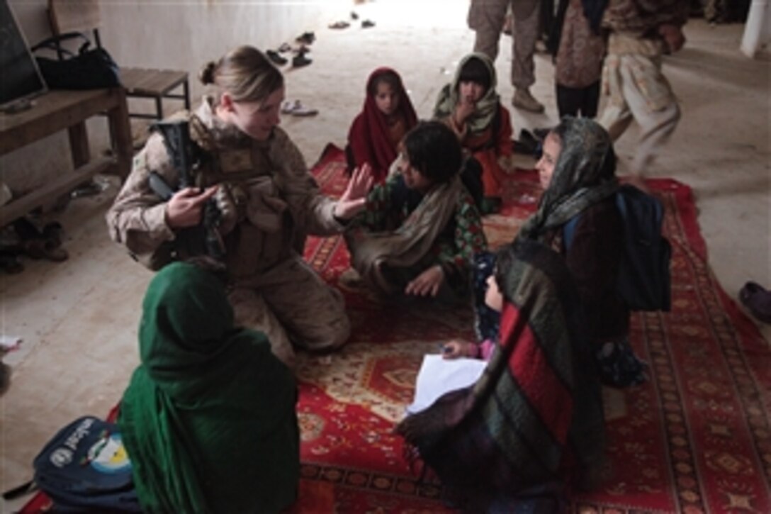 U.S. Marine Corps Cpl. Sarah B. Furrel, a member of the 3rd Battalion, 4th Marine Regiment's female engagement team, teaches Afghan girls to count numbers at a school in Now Zad, Afghanistan, on Jan. 2, 2010.  Furrel is at the school to encourage the girls to pursue an education.  
