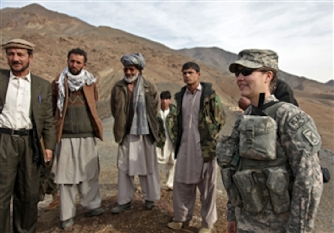 U.S. Air Force 1st Lt. Kathryn Miles, an engineer assigned to the Panjshir Provincial Reconstruction Team, Shah Murza, a representative from the Afghan Minister of Agriculture, and other Provincial Reconstruction Team members meet with Afghan locals on a hill top in the Anaba District of Panjshir Province, Afghanistan, on Jan. 2, 2010.  Provincial Reconstruction Team members are surveying a possible location for a water reservoir.  One of the problems within the Panjshir Province is the lack of potable water.  