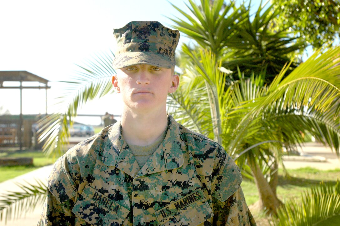 Pvt. Shane L. Barela, Platoon 3246, Co. L, was a former professional surfer in Hawaii before he enlisted in the Marine Corps.  After being awarded the coveted eagle, globe and anchor, Barela stands as he waits in line for his “Warrior’s Breakfast” Jan. 7, 2010.